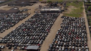 5.7K aerial stock footage of passing by rows of cars at an automobile junkyard in Phoenix, Arizona Aerial Stock Footage | DX0002_136_043