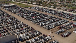 5.7K aerial stock footage pass and orbit rows of cars at an automobile junkyard in Phoenix, Arizona Aerial Stock Footage | DX0002_137_003