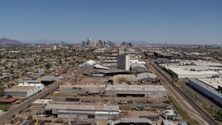 DX0002_137_007 - 5.7K aerial stock footage train tracks, grain elevator, and city skyline in Downtown Phoenix, Arizona