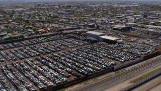 5.7K aerial stock footage pass and fly over rows of cars at an automobile junkyard in Phoenix, Arizona Aerial Stock Footage | DX0002_137_008