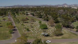 5.7K aerial stock footage orbiting green lawn and gravestones at a cemetery in Phoenix, Arizona Aerial Stock Footage | DX0002_137_026