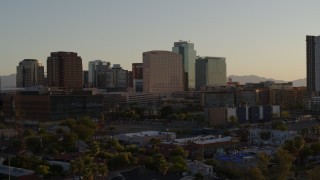 5.7K aerial stock footage of reverse view of a hotel and high-rise office buildings at sunset in Downtown Phoenix, Arizona Aerial Stock Footage | DX0002_138_048