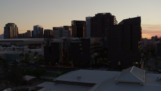 5.7K aerial stock footage of flying by college buildings at sunset in Downtown Phoenix, Arizona Aerial Stock Footage | DX0002_139_002