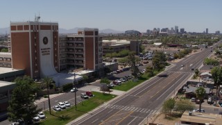 5.7K aerial stock footage pan from street and skyline to hospital complex in Phoenix, Arizona Aerial Stock Footage | DX0002_140_022