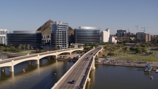 5.7K aerial stock footage orbiting waterfront office buildings seen from bridges spanning Tempe Town Lake in Tempe, Arizona Aerial Stock Footage | DX0002_142_010