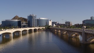 5.7K aerial stock footage descend between two bridges with view of modern office buildings in Tempe, Arizona Aerial Stock Footage | DX0002_142_014