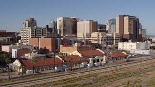 5.7K aerial stock footage of the city's skyline seen while flying past train station in Downtown Phoenix, Arizona Aerial Stock Footage | DX0002_142_016