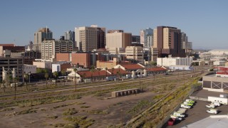 5.7K aerial stock footage of flying away from the city's skyline and train station in Downtown Phoenix, Arizona Aerial Stock Footage | DX0002_142_020