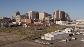 5.7K aerial stock footage ascend and approach the city's skyline behind train station in Downtown Phoenix, Arizona Aerial Stock Footage | DX0002_142_021