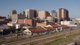 5.7K aerial stock footage of the city's skyline seen while flying past and away from train station in Downtown Phoenix, Arizona Aerial Stock Footage | DX0002_142_022