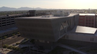 DX0002_142_030 - 5.7K aerial stock footage of circling the Maricopa County Sheriff’s Office at sunset in Downtown Phoenix, Arizona