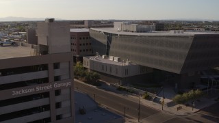 5.7K aerial stock footage fly away from the Maricopa County Sheriff’s Office and parking garage at sunset in Downtown Phoenix, Arizona Aerial Stock Footage | DX0002_142_035