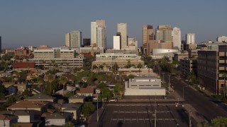 5.7K aerial stock footage flying by Adams Street leading to the city's skyline at sunset in Downtown Phoenix, Arizona Aerial Stock Footage | DX0002_143_005