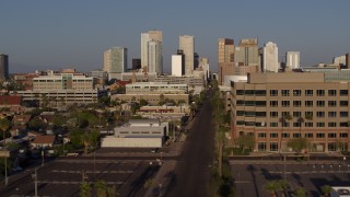 5.7K aerial stock footage flyby state offices and Adams Street for view of city's skyline at sunset in Downtown Phoenix, Arizona Aerial Stock Footage | DX0002_143_011