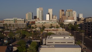 5.7K aerial stock footage follow Adams Street toward city's skyline at sunset in Downtown Phoenix, Arizona Aerial Stock Footage | DX0002_143_013