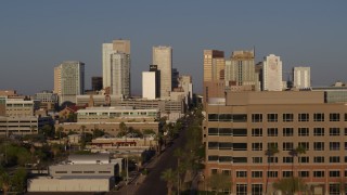 5.7K aerial stock footage flyby Adams Street and state office building, focus on city's skyline at sunset, Downtown Phoenix, Arizona Aerial Stock Footage | DX0002_143_014