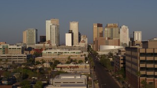 5.7K aerial stock footage flyby state office building to reveal Adams Street, focus on city's skyline at sunset, Downtown Phoenix, Arizona Aerial Stock Footage | DX0002_143_015