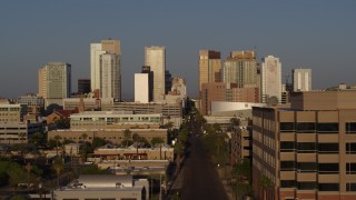 5.7K aerial stock footage follow Adams Street toward skyline of Downtown Phoenix, Arizona, sunset Aerial Stock Footage | DX0002_143_025