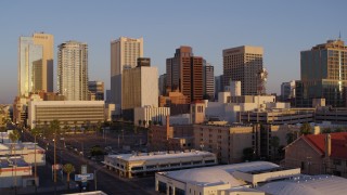 5.7K aerial stock footage of flying by tall buildings in the city's skyline of Downtown Phoenix, Arizona, sunset Aerial Stock Footage | DX0002_143_028