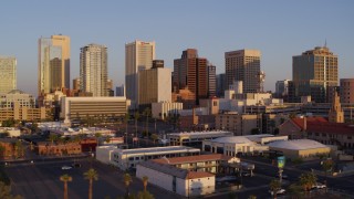 5.7K aerial stock footage of passing by tall buildings in the city's skyline of Downtown Phoenix, Arizona, sunset Aerial Stock Footage | DX0002_143_029