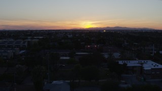 5.7K aerial stock footage of the sun setting behind distant mountains, seen from Phoenix, Arizona Aerial Stock Footage | DX0002_143_051