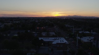 5.7K aerial stock footage of a view of the sun setting behind distant mountains, seen from Phoenix, Arizona Aerial Stock Footage | DX0002_143_052