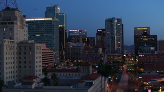 5.7K aerial stock footage of towering office buildings, reveal Westward Ho building at twilight, Downtown Phoenix, Arizona Aerial Stock Footage | DX0002_143_056