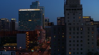 5.7K aerial stock footage passing high-rise office buildings, and reveal Westward Ho building at twilight, Downtown Phoenix, Arizona Aerial Stock Footage | DX0002_143_060