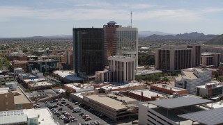 DX0002_144_008 - 5.7K aerial stock footage of a wide orbit around three tall office high-rises in Downtown Tucson, Arizona