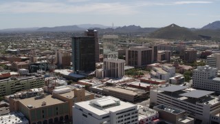 DX0002_144_009 - 5.7K aerial stock footage ascend past courthouse to orbit office high-rises and reveal Sentinel Peak, Downtown Tucson, Arizona