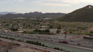 5.7K aerial stock footage pan across I-10 freeway to reveal Sentinel Peak in Tucson, Arizona Aerial Stock Footage | DX0002_145_026