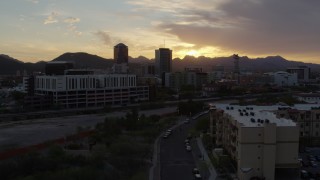 5.7K aerial stock footage flying away from tall office towers at sunset in Downtown Tucson, Arizona Aerial Stock Footage | DX0002_146_030