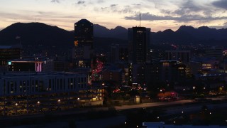 5.7K aerial stock footage ascend and approach tall office towers and Congress Street at twilight, Downtown Tucson, Arizona Aerial Stock Footage | DX0002_147_030