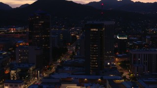 5.7K aerial stock footage circling tall office towers and reveal Congress Street at twilight, Downtown Tucson, Arizona Aerial Stock Footage | DX0002_147_033