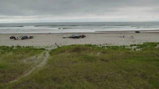 4K aerial stock footage approach and ascend near groups of people on the beach in Long Beach, Washington Aerial Stock Footage | DX0002_148_004