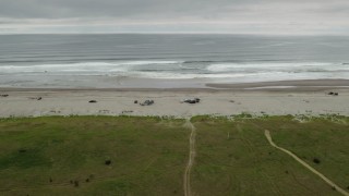 4K aerial stock footage of approaching people on the beach and ocean in Long Beach, Washington Aerial Stock Footage | DX0002_148_007