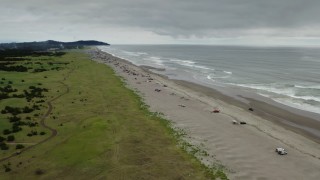 4K aerial stock footage approach people on the beach in Long Beach, Washington Aerial Stock Footage | DX0002_148_010