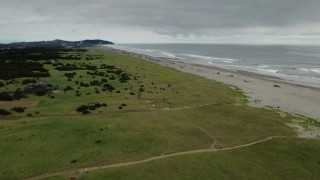 4K aerial stock footage of flying away from people on the beach in Long Beach, Washington Aerial Stock Footage | DX0002_148_012