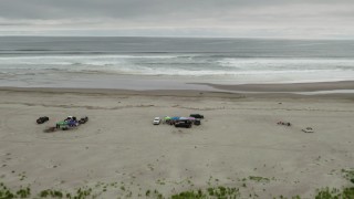 4K aerial stock footage fly away from people on the beach and ocean in Long Beach, Washington Aerial Stock Footage | DX0002_148_014