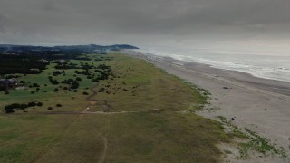 4K aerial stock footage descend and approach the beach as fireworks go off at sunset in Long Beach, Washington Aerial Stock Footage | DX0002_148_031