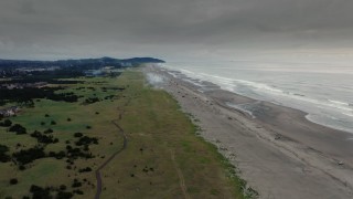 4K aerial stock footage fly away from the beach at sunset in Long Beach, Washington Aerial Stock Footage | DX0002_148_033