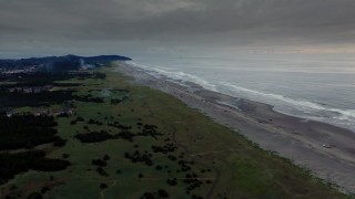 4K aerial stock footage fly away from the beach revealing fireworks at sunset in Long Beach, Washington Aerial Stock Footage | DX0002_148_039