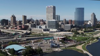 5.7K aerial stock footage of tall skyscrapers seen while flying near an outdoor stage in Downtown Milwaukee, Wisconsin Aerial Stock Footage | DX0002_149_029