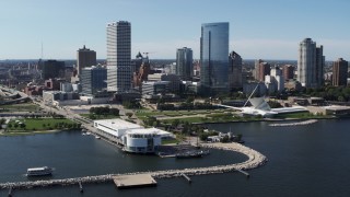 5.7K aerial stock footage of a view of tall skyscrapers seen while flying by Discover World museum in Downtown Milwaukee, Wisconsin Aerial Stock Footage | DX0002_149_033