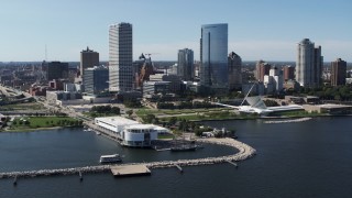 5.7K aerial stock footage of a view of skyscrapers seen while passing Discover World museum in Downtown Milwaukee, Wisconsin Aerial Stock Footage | DX0002_149_034