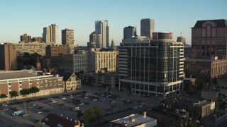 DX0002_150_011 - 5.7K aerial stock footage of flying away from a dormitory complex at sunset in Downtown Milwaukee, Wisconsin