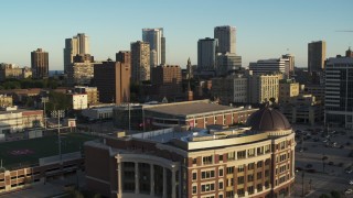 5.7K aerial stock footage of ascending from a college building for a view of the skyline at sunset in Downtown Milwaukee, Wisconsin Aerial Stock Footage | DX0002_150_014