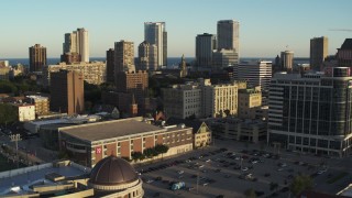 DX0002_150_015 - 5.7K aerial stock footage of a view of the skyline while flying by dormitory building at sunset in Downtown Milwaukee, Wisconsin