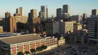 5.7K aerial stock footage descend by college campus at sunset with view of city skyline, Downtown Milwaukee, Wisconsin Aerial Stock Footage | DX0002_150_021