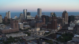 5.7K aerial stock footage city buildings and skyscrapers seen from Milwaukee River at twilight, Downtown Milwaukee, Wisconsin Aerial Stock Footage | DX0002_150_029